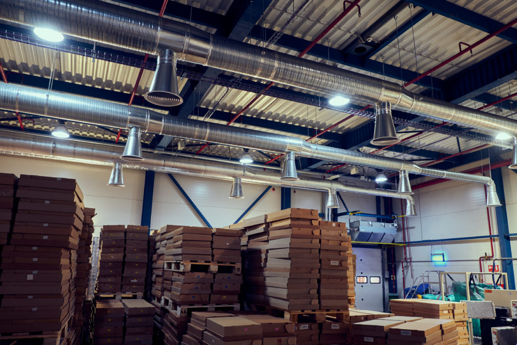 Warehouse with modern ventilation system full of raw material. | Sky Point Crane | Sky Point Crane