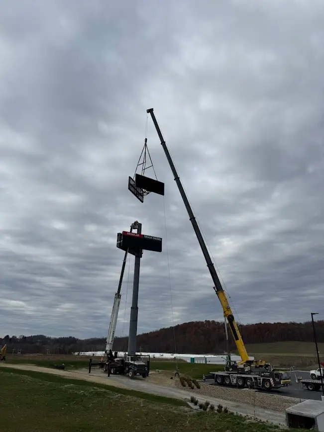 Large digital sign being lifted by Sky Point Crane's large 225 T all terrain crane at a truck stop near Washington, PA