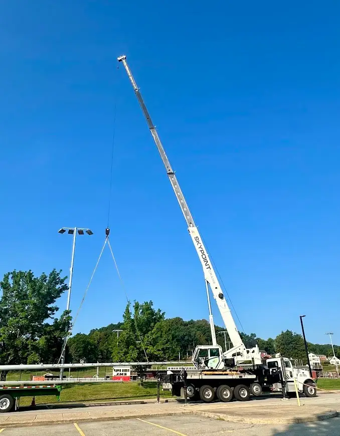 Removing light poles at a football field near Harrisville, PA